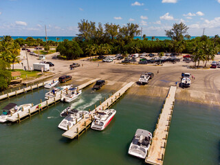 Trucks loading boats down ramp at marina Miami aerial photo