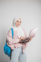 asian muslim student holding laptop in front of white background