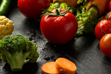Carrots and vegetables on black background in studio