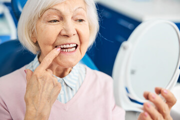 Woman performing a check of her loose tooth