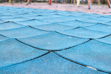 broken rubber tiles in the playground, old Poured-in-Place, PIP, tartan surface, damaged, worn out