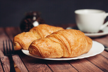 crispy croissants on a plate kitchen utensils for breakfast meal dessert