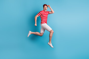 Fototapeta na wymiar Full length body side profile photo man jumping running fast on sale amazed cheerful isolated on bright blue color background