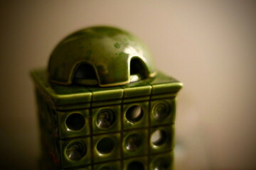 Close-up of classy fragrance lamp in the style of a tiled stove