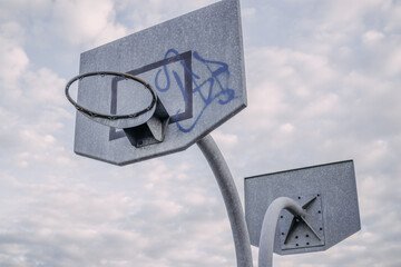 Metal basketball backboard with hoop,  gray sky, rim, playground © photosvideos