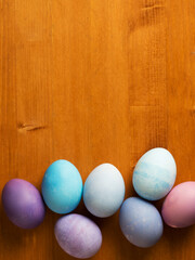 Easter eggs on a wooden table, copy space