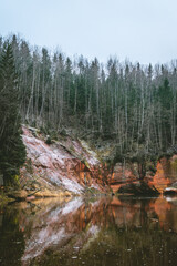 Fototapeta na wymiar Springu (Spriņģu) cliffs by the Gauja river in the Gauja National park. Sandstone rock by a river in Latvia