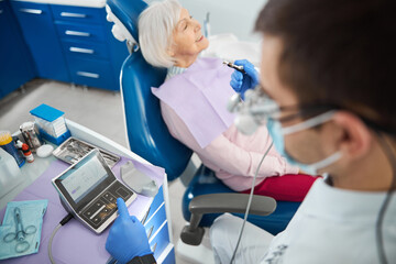 Dentist setting parameters for dental drill in controller © Svitlana