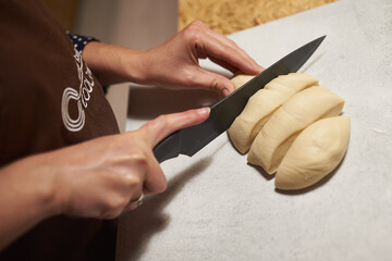 baker wearing apron slice dough