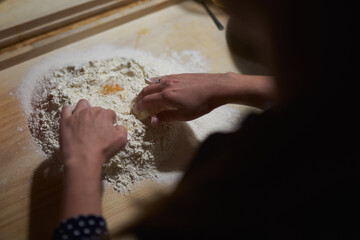 participant of culinary workshops mix flour and eggs for bread