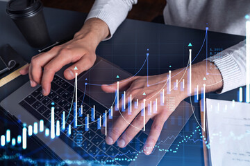 Hands typing the keyboard to research stock market to proceed right investment solutions. Internet trading and wealth management concept. Hologram Forex chart over close up shot.