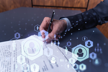 A potential employee in formal suit signing the contract to boost his career and gain new...