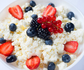 Healthy breakfast: cottage cheese with strawberries, blueberries and blackberries