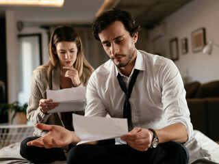 Husband and wife preparing bills to pay. Couple having financial problems.