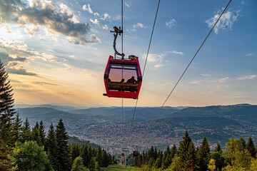 Twilight panorama  with  a gondola floating between sunset sky and earth, foggy mountains, foggy...