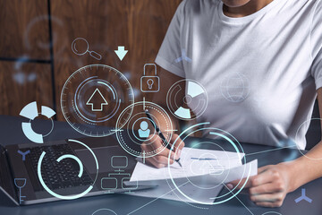 A client is signing a contract to create a new software to present it in start up conference and gain investments to create a product. Technological graph over the desk. Women in business concept.