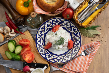 Vegetable salad of radishes, cucumbers and tomatoes seasoned with sour cream