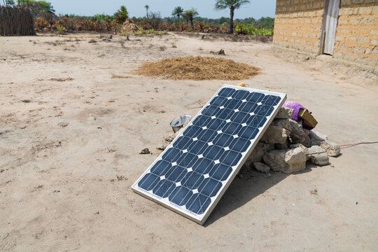 Solar panel resting on rocks in West Africa