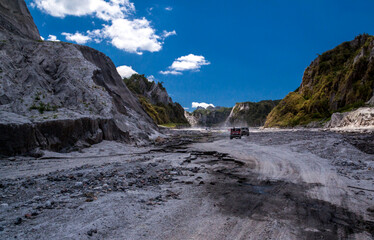 Fototapeta na wymiar valley cretaed by the lahar flow during the volcano Mt. Pinatubo eruption in the early 1990's. Now its a tourist spot where tourists hire 4x4 vehicles to traverse the rocky terrain to reach crater.
