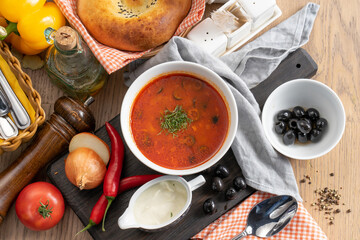 Vegetarian tomato soup with olives, sour cream and dill