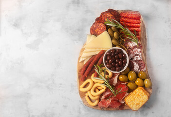 Fototapeta na wymiar Charcuterie board with spanish jamon, pork sausage with pepper, fuet, cheese and berries. Image with copy space