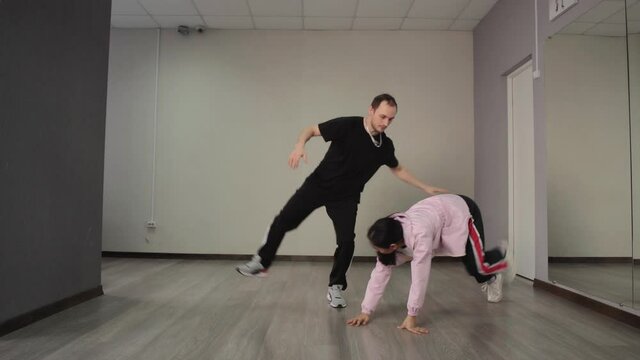 Hip hop dance performed by man and woman in the studio