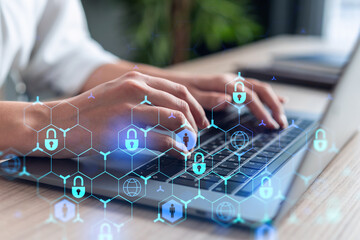 A woman programmer is typing a code on computer to protect a cyber security from hacker attacks and...