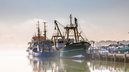 Fototapeta na wymiar Modern fishing ships in hazy weather haringvliet
