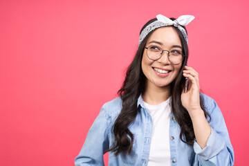 Young smiling Asian woman using a mobile phone.