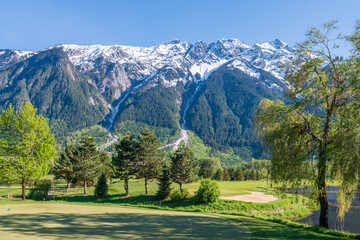 Golf course with gorgeous green and fantastic mountains view.