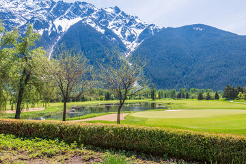 Golf course with gorgeous green and fantastic mountains view.