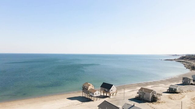 Aerial Drone shot of beach houses at Peggotty Beach, Scituate, Massachusetts.  Forward riding shot