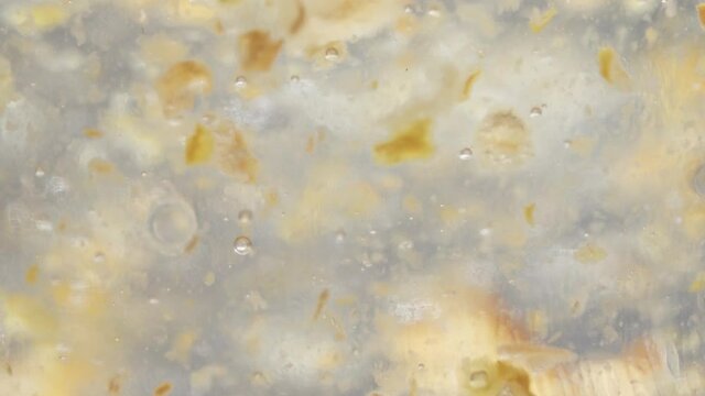 Golden texture macro in a heavy liquid in motion