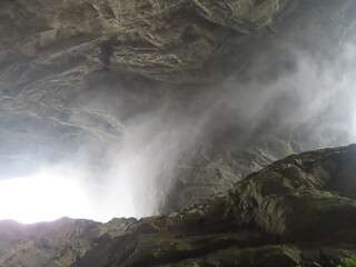 Wu Long Park Landscapes Near Chongqing, China, with Clouds Streaming Through a Natural Bridge...