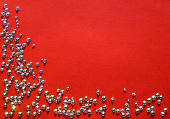 rhinestones on a red background, top photo. design for text
