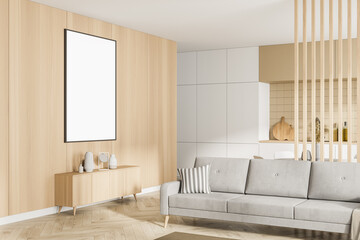 Modern kitchen interior and living area. Studio apartment concept. Furnished by beige sofa, sideboard and one white empty framed poster on wooden wall. Mock up.