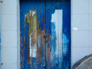 white painted number on old weathered blue door