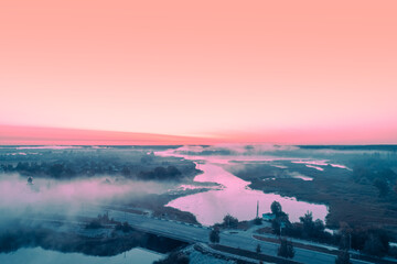 Early foggy morning over the river. Bridge over the river. Bird's-eye