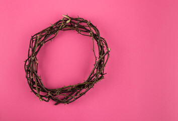 Crown of thorns on pink background.