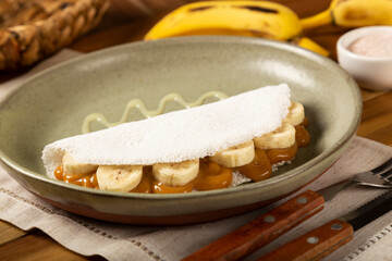 Sweet tapioca stuffed with dulce de leche and banana. Brazilian tapioca.