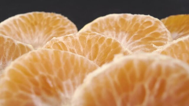 Tangerine slices close up. Textured peeled mandarin surface. Macro. Dolly Shot