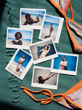 Polaroid photos of girl in bikini on the beach are scattered on towel
