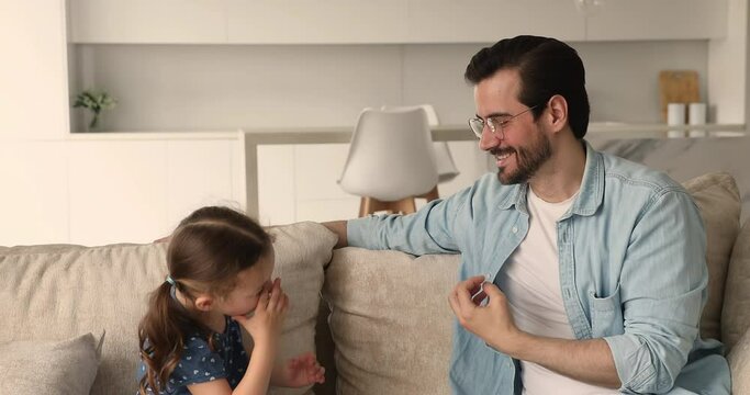 Little preschooler stuttering girl involved in speaking pronunciation lesson, do vocal exercise, learn pronouncing words correctly with professional male speech therapist. Caring dad teach kid concept