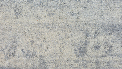 Concrete texture, light gray fine-grained with an overflow of lights close-up