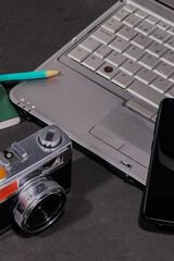 Obraz premium Composition of a laptop, a mobile and an old camera
