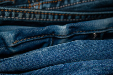 Fototapeta premium Background on the theme of denim clothing. Denim fabric with elements of seams.