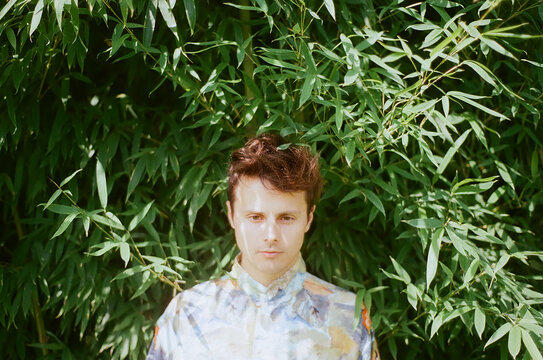 A photo of a beautiful man in a bamboo