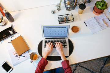 Unrecognizable woman using laptop for freelance job