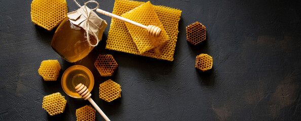 Healthy Thick honey dipping from the wooden honey spoon, bee products by organic natural...