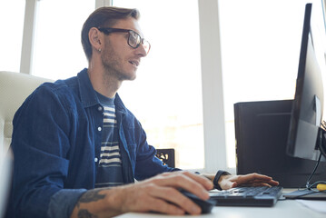 Male IT Developer Using Computer Side View